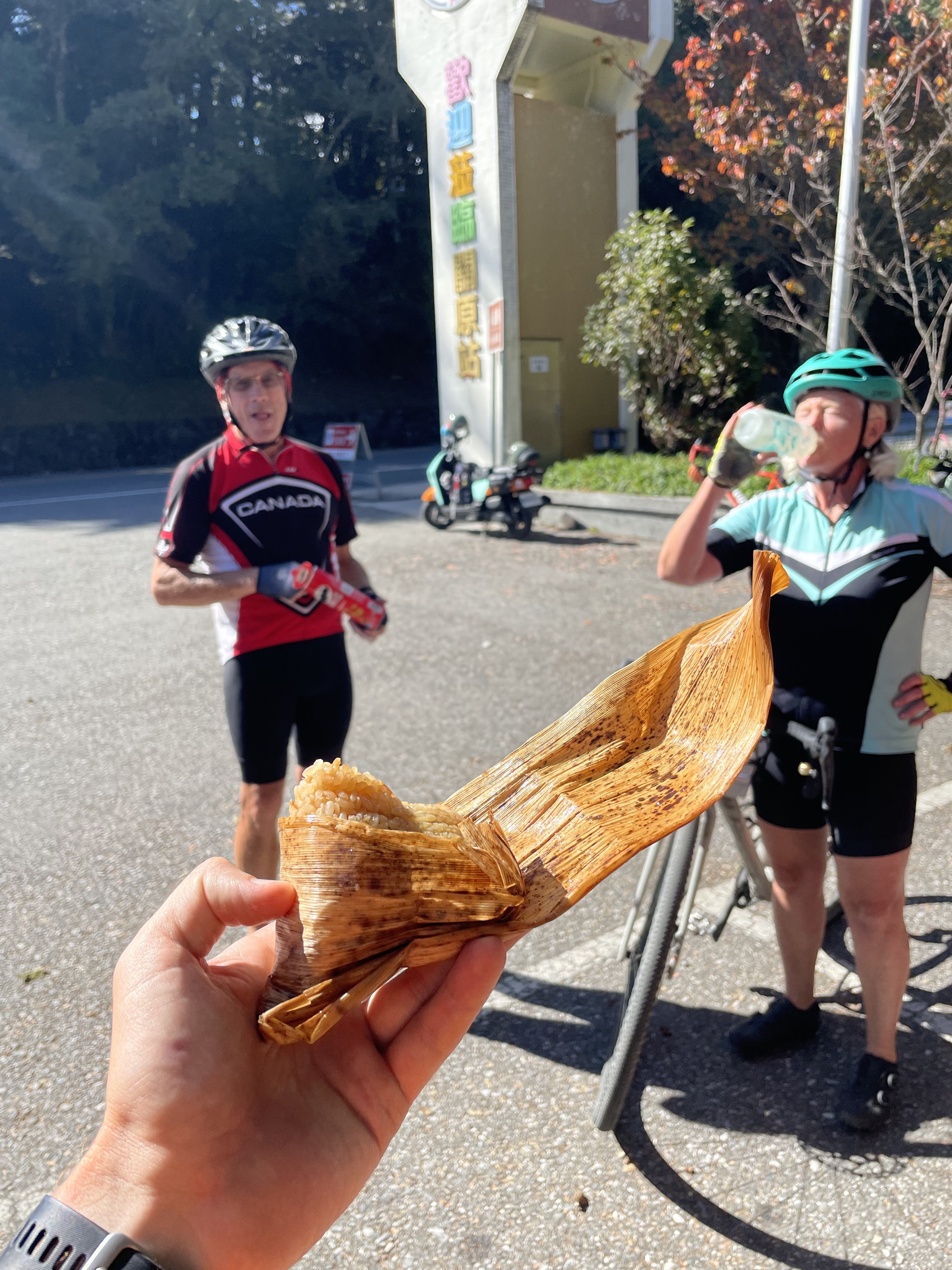 Cyclist holding grilled corn snack