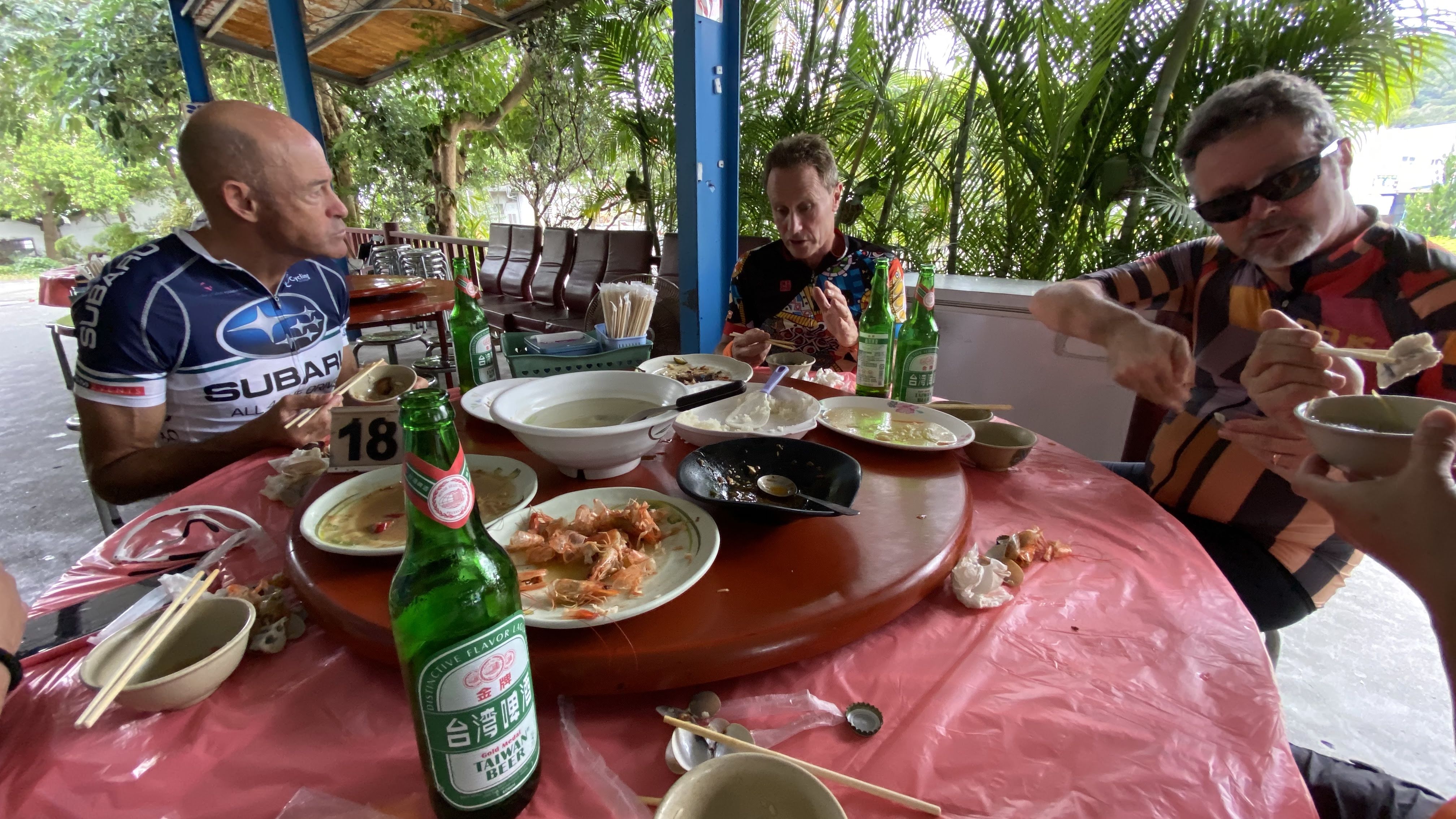 Cyclists enjoying meal at outdoor table